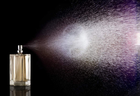 Travel-size perfume bottle being sprayed — travel-friendly fragrances in 2026
