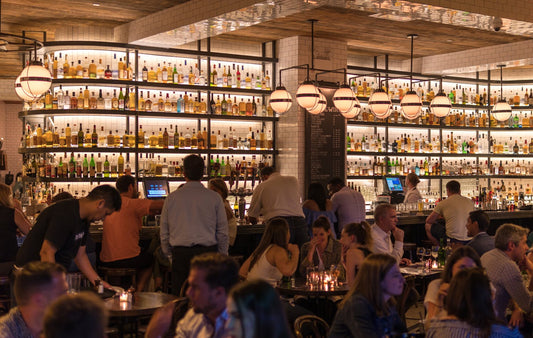 dim speakeasy bar with amber glassware