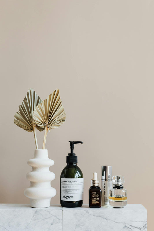 Soft draped fabric and warm light - Fragrenza guide to layering skin scents with vanilla, oud, or florals
